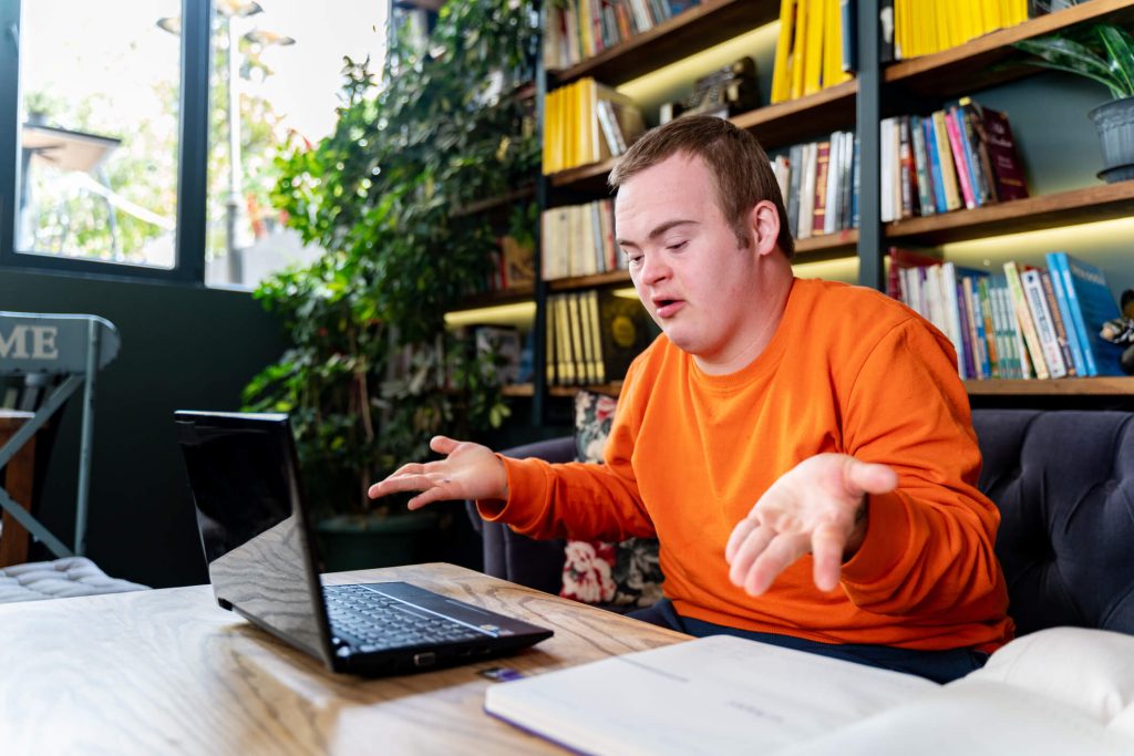 Person with disability talking to someone via a laptop